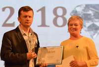 Юлия Константинова, редактор программ РТС, передаёт диплом «Журналист года» победителю в этой номинации Александру Дубровину.