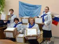 Руководитель Союза женщин России в Респуб­лике Хакасия Любовь Безлепкина с активистами организации и посылками из дома. 